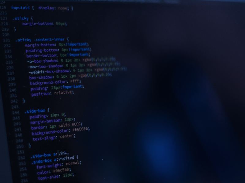 Lines of website code on a dark computer screen.